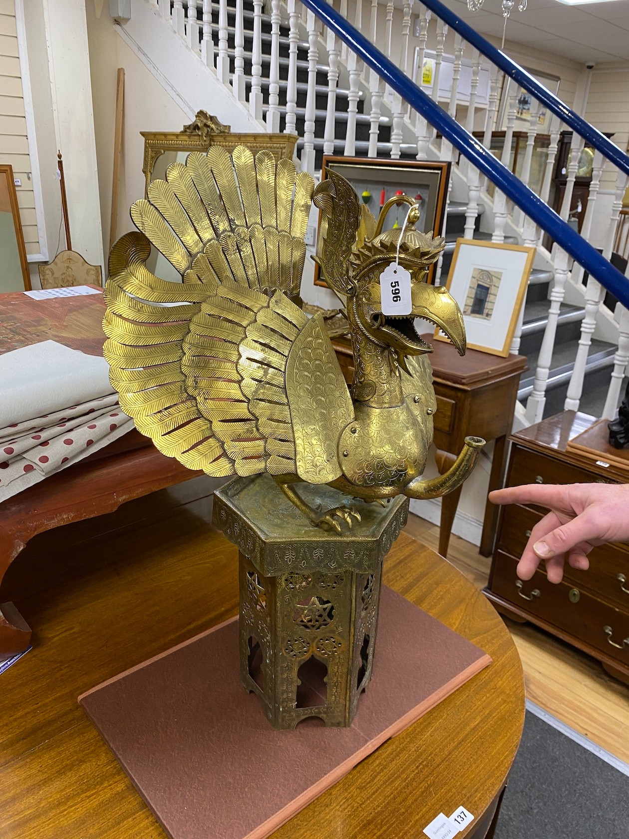 A large Indonesian brass Garuda figural oil lamp and a Islamic brass stand, 82cm tall